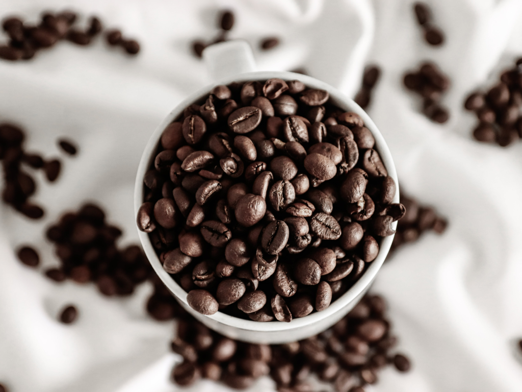 https://www.pexels.com/photo/coffee-beans-in-ceramic-cup-on-white-cloth-7752766/